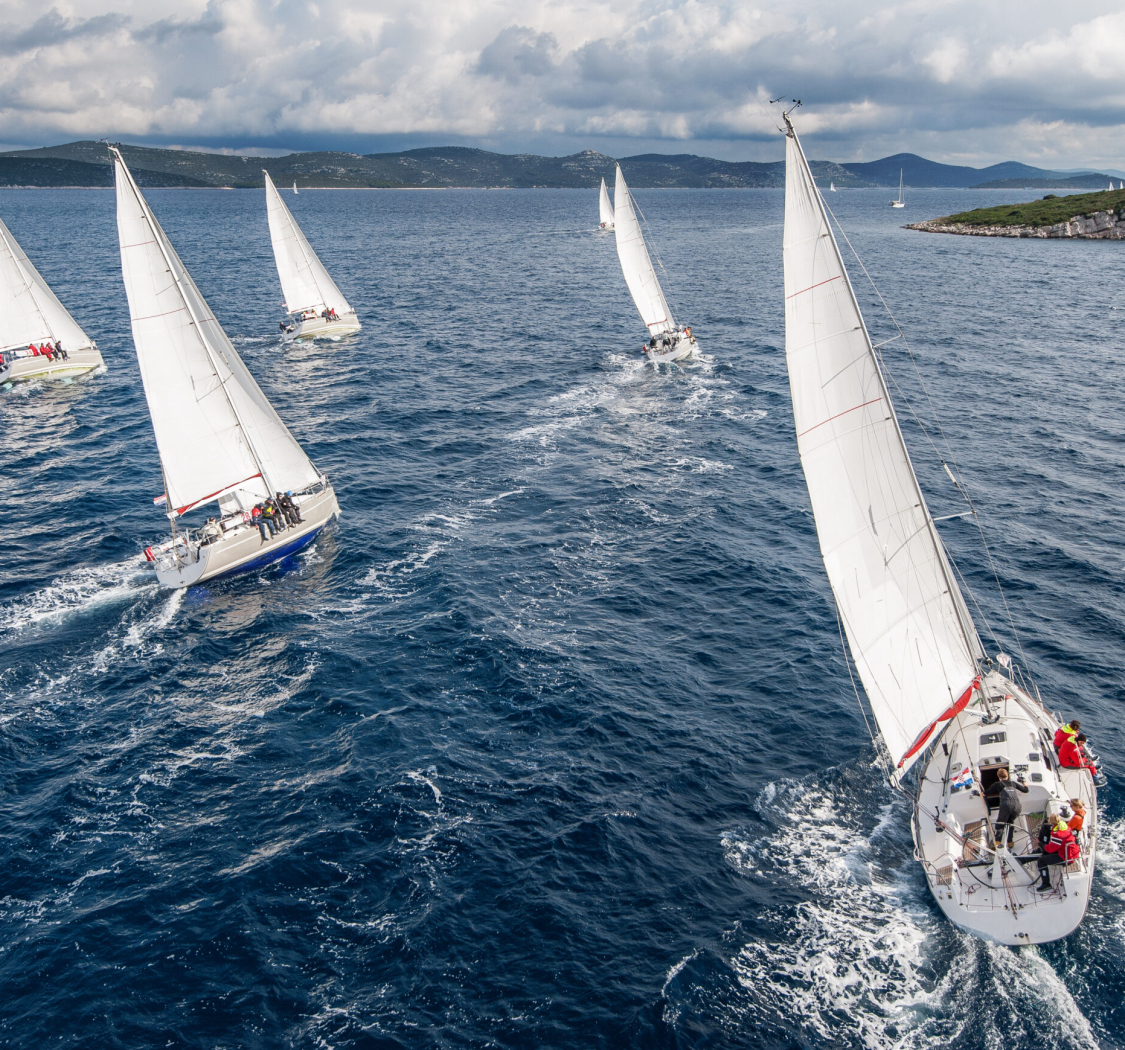 Fleet of sailing boats during offshore race from bird view
